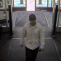 Surveillance photo of the suspect in the April, 2014 credit card theft case, later identified as Joseph Mignano.