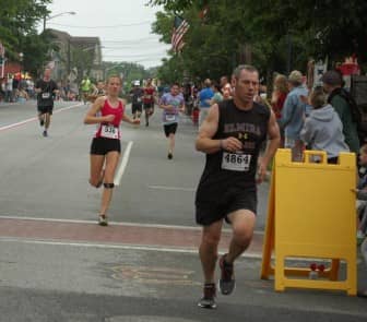 Kevin Anderson of Coventry, right, rounds the final corner of the 2014 Gaspee Days 5K.