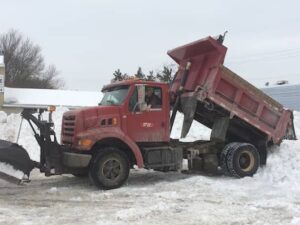 Leo Beausoleil deposits a load of snow cleared from Gregg's parking lot into an adjacent lot Thursday morning, Feb. 5, 2015.