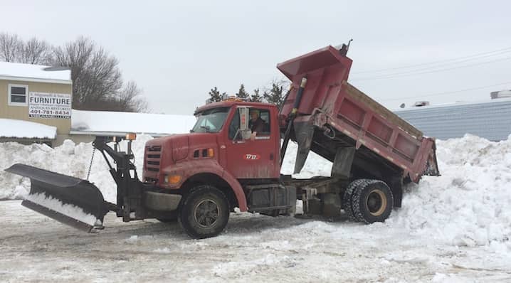 Leo Beausoleil deposits a load of snow cleared from Gregg's parking lot into an adjacent lot Thursday morning, Feb. 5, 2015.