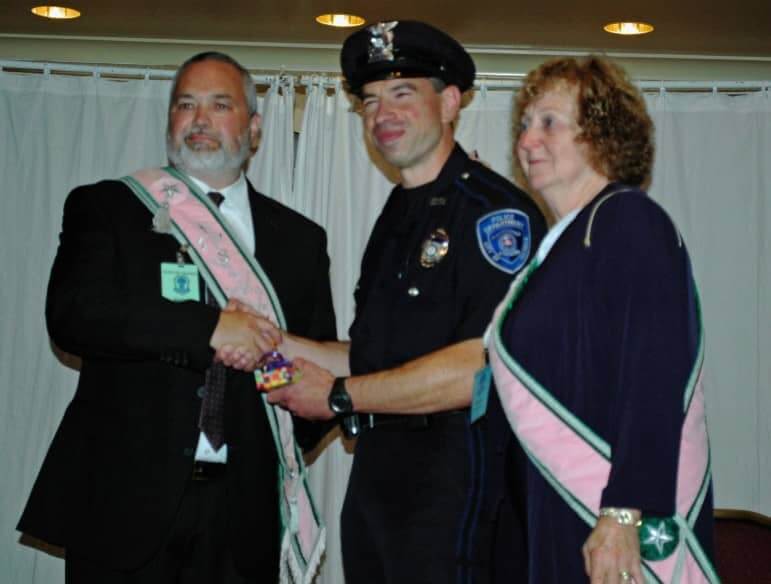 From left, Walter Hartley, RI State Grange Steward, Officer Steve Lombardi, and Marie Robidoux as Lombardi was presented with the Officer of the Year Award  at the Radisson Hotel on Post Road.