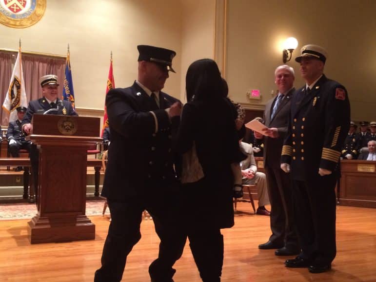 [CREDIT: Rob Borkowski] [CREDIT: Rob Borkowski] WFD Lt. Christopher Albro is pinned by hs wife, Allison, carrying their daughter, Brooke.