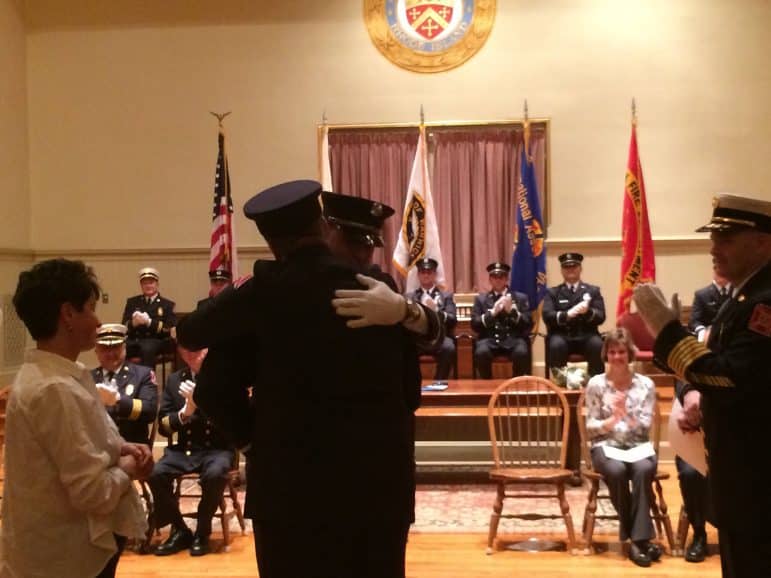 [CREDIT: Rob Borkowski] Bradford Ginaitt newly sworn in Rescue Lt., is pinned by his parents, retired Rescue Captain Richard and Mother, Sharon.