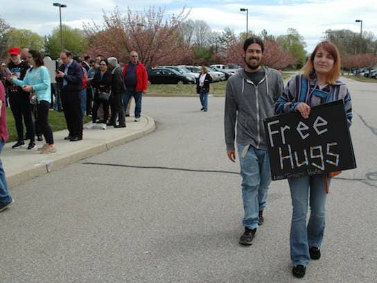 [CREDIT: Rob Borkowski] Micaela Stuttard and Tim Silva of East Providence offered free hugs to supporters at Crowne Plaza waiting to hear Donald Trump speak April 25.