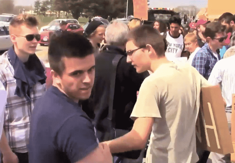 [CREDIT: Roderick Webber] A man attempts to pull a protester's sign, reading "Stop Hate" from his grasp at the Trump rally at Crowne Plaza April 25, tearing it in half. The man stopped as Roderick challenged him, asking if he was taking the man's belongings. "Yup," the man replied. 