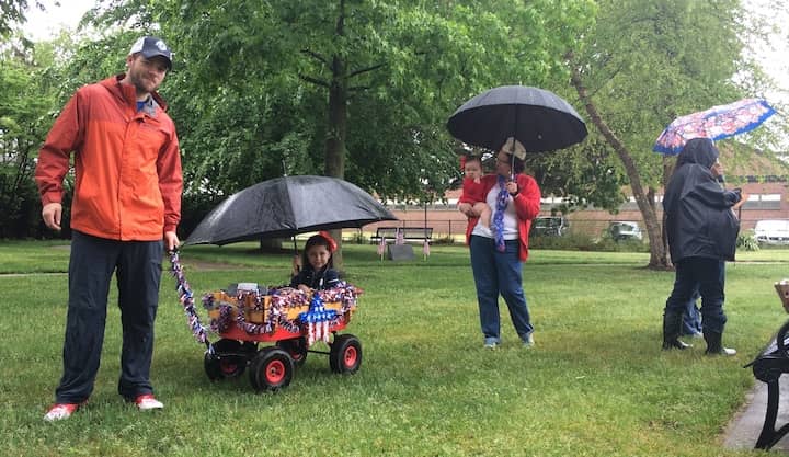 CREDIT: Rob Borkowski] Jacob Burrows tows his niece, Mary Burrows, around the Warwick Veterans Memorial on West Shore Road on Memorial Day in 2016. Following them is Mary's grandmother, Debra Burrows.