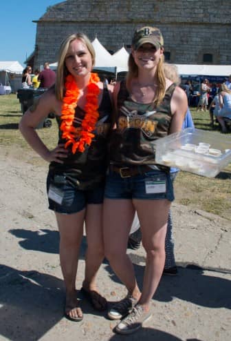 [CREDIT: Mary Carlos] From left, Briana Tomassini and Leah Norberg pass out samples of Open Season chowder. "We're his hype girls," Briana said.