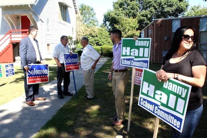 [CREDIT: Beth Hurd]   Candidates Joseph J. Solomon, Jr., democrat, State Representative (at left) and Danny Hall, democrat running for school committee (second from right), joined by former councilman Carlo Pisaturo, (second from left) greet voters as they entered the polling place at Heritage Christian Fellowship Church on Warwick Neck Avenue.