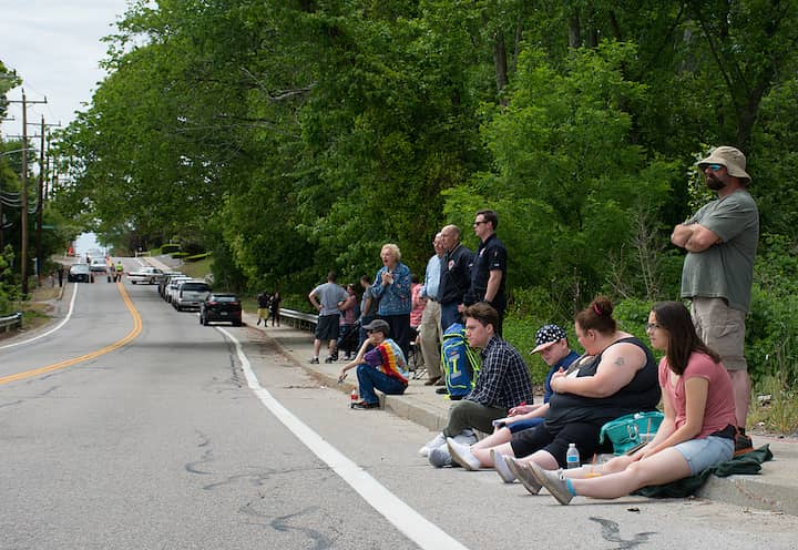 [CREDIT: Mary Carlos] From left, Roberto Conti, Ethan Paiva, Casaundra Lefrancious, David Paiva, and Isabelle Lefrancious, wait on Cowesett Avenue for the Station Memorial dedication.