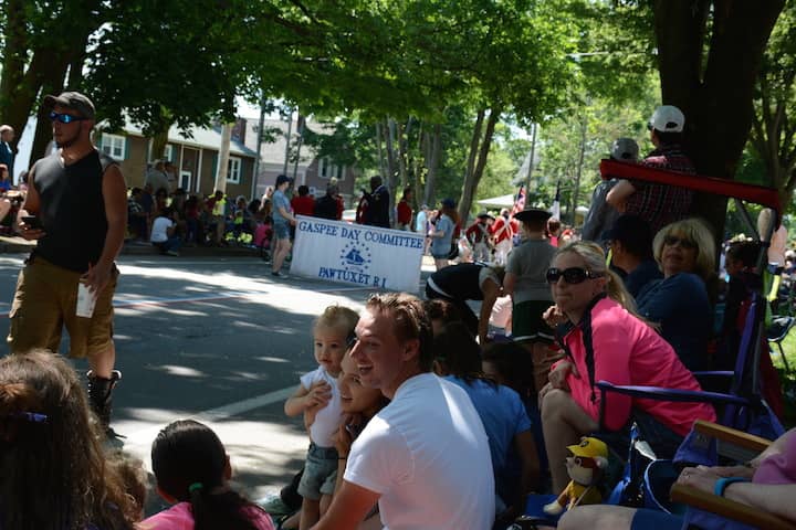 [CREDIT: Rob Borkowski] At right, Amy Beausoleil, in pink waits for the 2017 Gaspee Day Parade with her son (white T-shirt) Sonny, daughter- in-law Bella and their son, 