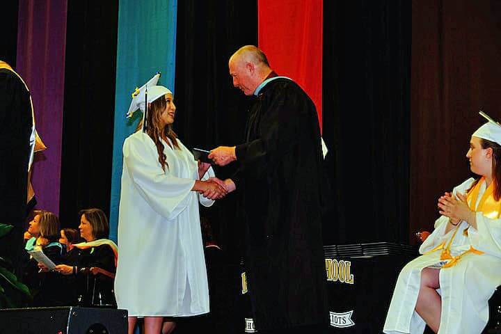 [CREDIT: Lauren Kasz] Principal Gerald Habershaw shakes the hand of a new graduate at CCRI during the Pilgrim High School Class of 2017 graduation.