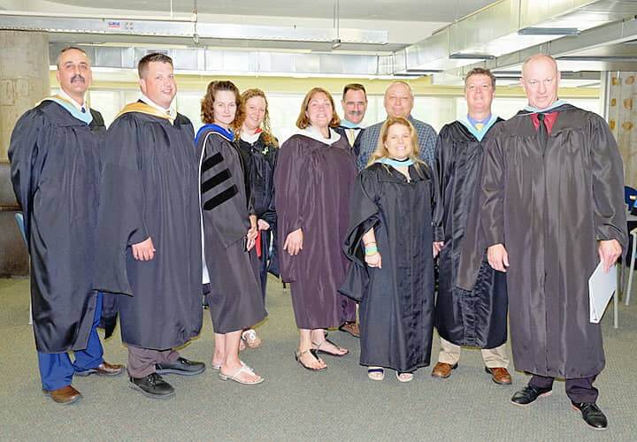 [CREDIT: Lauren Kasz] Pilgrim and Warwick faculty and staff members prepare to lead the evening's processional at CCRI during the Pilgrim High School Class of 2017 graduation.