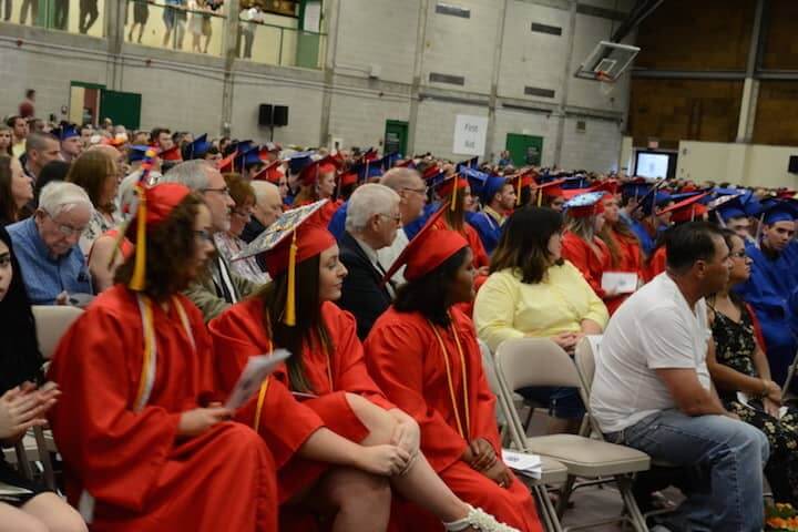 [CREDIT: Rob Borkowski] Toll Gate grads Lauren Kellerman, Alyssa Ferreira and Precious Peov wait for their diplomas Tuesday at CCRI. 