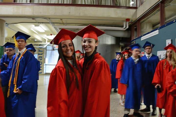 [CREDIT: Rob Borkowski] Toll Gate grads Marisa Girard and Courtney Iadevaia wait for their diplomas Tuesday at CCRI. 