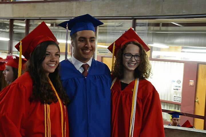 [CREDIT: Rob Borkowski] Nick Zulla takes a photo of Gwendolyn Kalian, Nick Kazandjian, and Lauren Kellerman as they wait for their diplomas Tuesday at CCRI. 