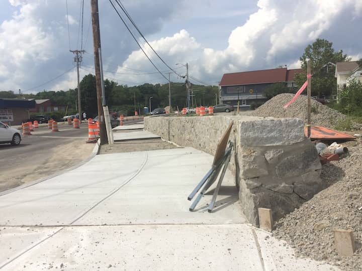 [CREDIT: Rob Borkowski]  A stone wall along Greenwich Avenue facing away from Apponaug Four Corners toward Veterans Memorial Drive.