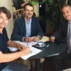 [CREDIT: Gamm Theatre] L to R: Gamm Managing Director Oliver Dow, Stephen Soscia of Mutual Property Associates, Gamm Board President Leon C. Boghossian III sign the lease for Gamm Theatre to move to 1245 Jefferson Blvd., in the building once occupied by Ocean State Theatre.