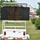 [CREDIT: Robert Ford] An electronic messaging sign urging Coventry voters to get out and vote on the revised town and school budgets, June 13 stands at the intersection of Sandy Bottom and Tiogue Avenue.