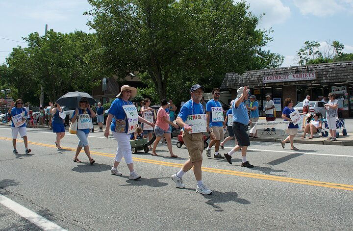 [CREDIT: Mary Carlos] Organizers of the Conimicut Apollo 11 parade carried signs thanking sponsors and contributors to the parade July 20, 2019.