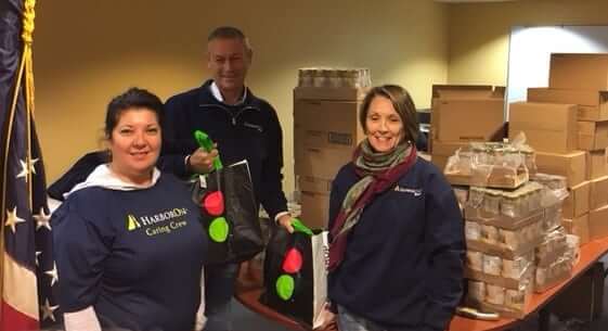 [CREDIT: BGCW] HarborOne volunteers played an important role by packing more than 200 bags of sides for each family aided by Stop&Shop donated turkeys.Pictured from left to right are HarborOne employees Maria Boyle, Steve Gibbons and Kathy Goulding.