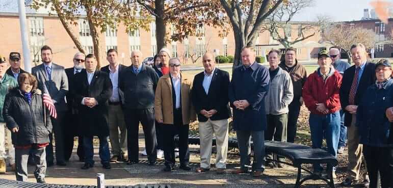 [CREDIT: Kim Wineman] Several Warwick officials attended Warwick's Veterans Day ceremony at Warwick Veterans Memorial Jr. High Nov. 11, 2019. Attending were From left, Councilors Donna Travis, Ed Ladouceur and Jeremy Rix, Rep. Dave Bennett, (D-Dist. 20), Rep. Joseph J. Solomon Jr., (D - Dist. 22), Councilor Jim Mcelroy (tan coat), Warwick Mayor Joseph J. Solomon, Sen. Michael J. McCaffrey, Councilor Richard Corley, and at far right, Sen. Mark McKenney, (D-Dist. 30) and Rep. Camille Vella Wilkinson (D – Dist. 21).