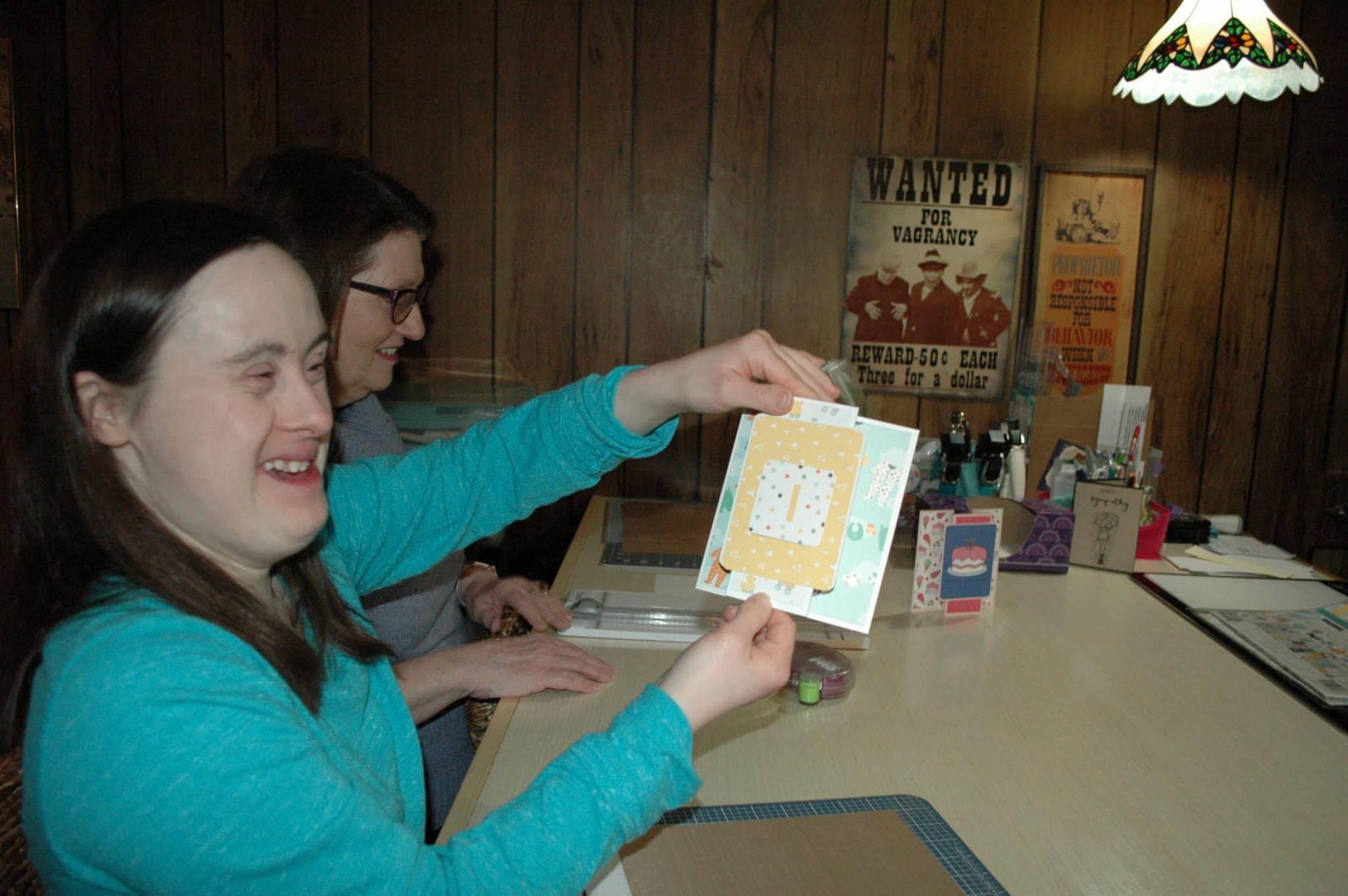 [CREDIT: Rob Borkowski] Katie Lowe, owner of Cheetah Greetings, shows off one of her hand-crafted greeting cards. She learned about marketing her business at a RIDDC workshop.