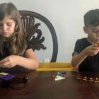 Liliana, 6 and Rocco, 4 from Houston, TX, work on a remote STEAM ship lesson in buoyancy from the Steamship Historical Society of America. They built a LEGO boat to test how things float while at home during the COVID-19 crisis.