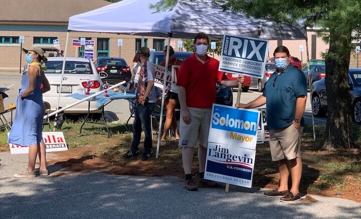 [CREDIT: Rob Borkowski] From left, in red, Councilmen Jeremy Rix and Steve McAllister hold signs outside the Pilgrim Senior Center during the 2020 statewide primary Sept. 8. 