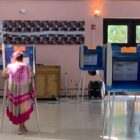 [CREDIT: Rob Borkowski] A woman casts her ballot at Pilgrim Senior Center Tuesday, Sept. 8, 2020. Many cast ballots by emergency and mail in systems,