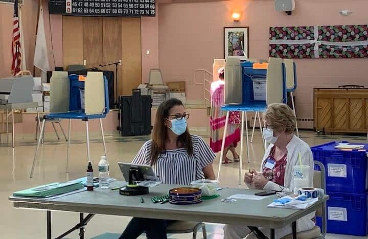 [CREDIT: Rob Borkowski] From left, poll workers Julie Thurston and Marge Ovalles wait for the next round of voters to pass through Pilgrim Senior Center during the 2020 statewide primary Sept. 8.