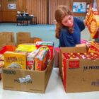 [CREDIT: Linc Smith] Emily McGuire packs the cereal from the Second Cereal Challenge for Westbay Marketplace.