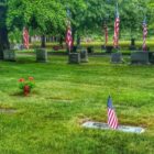 [CREDIT: Lincoln Smith] Pawtuxet Memorial Park graves are bedecked with flowers and flags each Memorial Day.