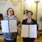 [CREDIT: Legislative Press and Public Information Bureau] Rep. Camille F.J. Vella-Wilkinson (D-Dist. 21, Warwick), left, and Sen. Melissa A. Murray (D-Dist. 24, Woonsocket, North Smithfield) are seen at today’s bill-signing ceremony in the Governor’s Reception Room at the State House.