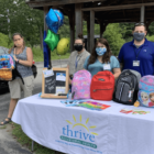 [CREDIT: Thrive] Members of Thrive Behavioral Health’s Youth & Family Services Team hand out backpacks and school supplies to the program’s children and families as part of their Back-To-School Supply Drive.