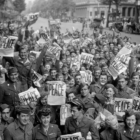 [CREDIT: National Archives] American service members gather in front of the Red Cross club in Paris to celebrate the unconditional surrender of the Japanese, Aug. 15, 1945.