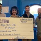 [CREDIT: BGCW] Presenting a $1,000 donation check to the Boys & Girls Club of Warwick's Chief Executive Pfficer Lara D’Antuono are, True Storage team members Josh Gagne, Ben Kfoury and Jacob Fuller.