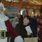 [CREDIT: Rob Borkowski] Santa was one of the many attractions at the RI Author Expo at Rhodes on the Pawtuxet Dec. 7, 2019. From left are Santa, played by Michael Silva, his granddaughter Riley Silva, 9, months, Mary Ann Guerin and Rhoda Silva.