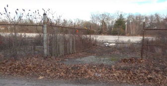 [CREDIT: Jeff Sutton] An open gate at 175 Post Road, one example of unsecured access to the property, say members of the Pawtuxet Green Revival.