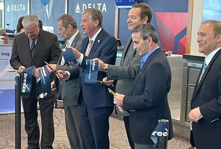 [CREDIT: Rob Borkowski] Officials and Mike Wuerger, Chief Operations Officer for Breeze Airways, attended a brief ribbon cutting on the inaugural day of the airline's base of operations at TF Green Airport. From left, RIAC Board Chair Jonathan Savage, Senate President Dominick Ruggerio, Gov. Dan McKee, Wuerger, and Warwick Mayor Frank Picozzi. 