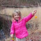 [CREDIT: DEM] An angler shows off her catch during a previous Trout Season Opening Day.