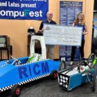 [CREDIT: RIHEBC] From left, Dan Berman, Rhode Island Computer Museum and Kim Mooers, RIHEBC. RIHEBC presented the museum with a $25,000 loan for EV car kits during their open house Aug. 9 at the museum's new Warwick location.