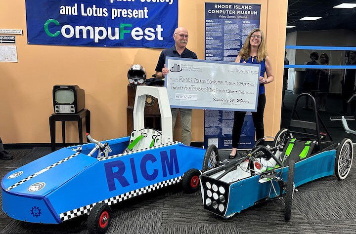 [CREDIT: RIHEBC] From left, Dan Berman, Rhode Island Computer Museum and Kim Mooers, RIHEBC. RIHEBC presented the museum with a $25,000 loan for EV car kits during their open house Aug. 9 at the museum's new Warwick location.