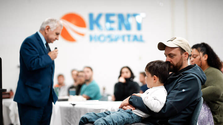 [CREDIT: CNE] U.S. Sen. Jack Reed speaks during a ceremony honoring Kent Hospital ER doctor and U.S. Army Reserve Medical Corps Major  Dr. Benjamin Misemer Oct. 12, 2023. Sitting with Misemer is his son, Owen.