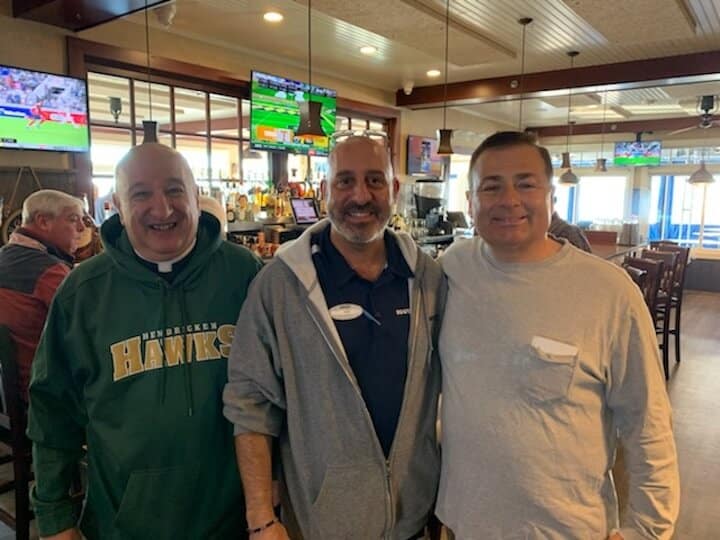  [CREDIT: Courtesy Kim Wineman] From left, former Mayor Scott Avedisian, Rev. Robert L. Marciano, and David Gravino, owner of Iggy's, during Iggy's Doughboy and Chowder House's free Veterans Day breakfast Saturday, Nov. 11, 2023.