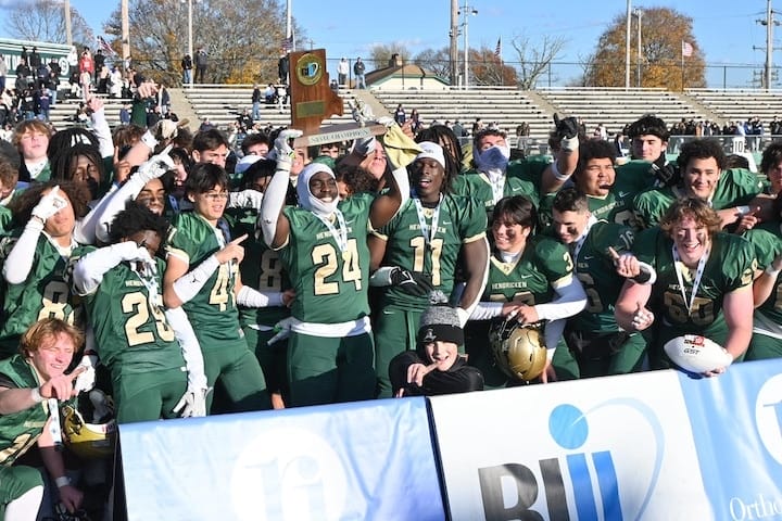 [CREDIT: Bishop Hendricken High School/Facebook] Bishop Hendricken senior QB Ronjai Francis (24) raises the Division 1 Super Bowl trophy after the Hawks defeated North Kingstown, 35-7.