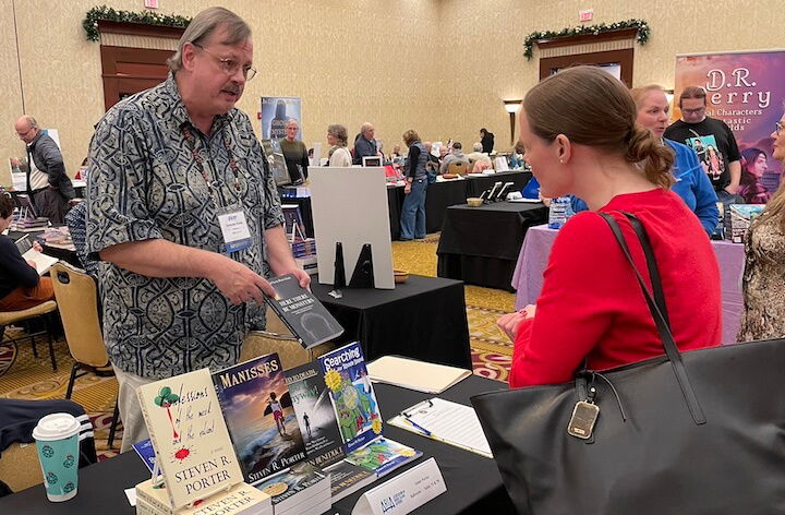 [CREDIT: Rob Borkowski] Steve Porter, owner of Stillwater Books and organizer of the Author Expo, speaks with Dr. Mary Anderson, author of "The Happy High Achiever," during the RI Author Expo at Crowne Plaza Warwick Saturday.