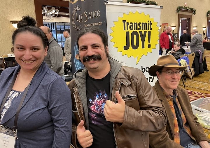  [CREDIT: Rob Borkowski] A leftt, fantasy author Liz Sauco, and at far right, Mark Binder, at the RI Author Expo Saturday at Crowne Plaza Warwick, RI. 