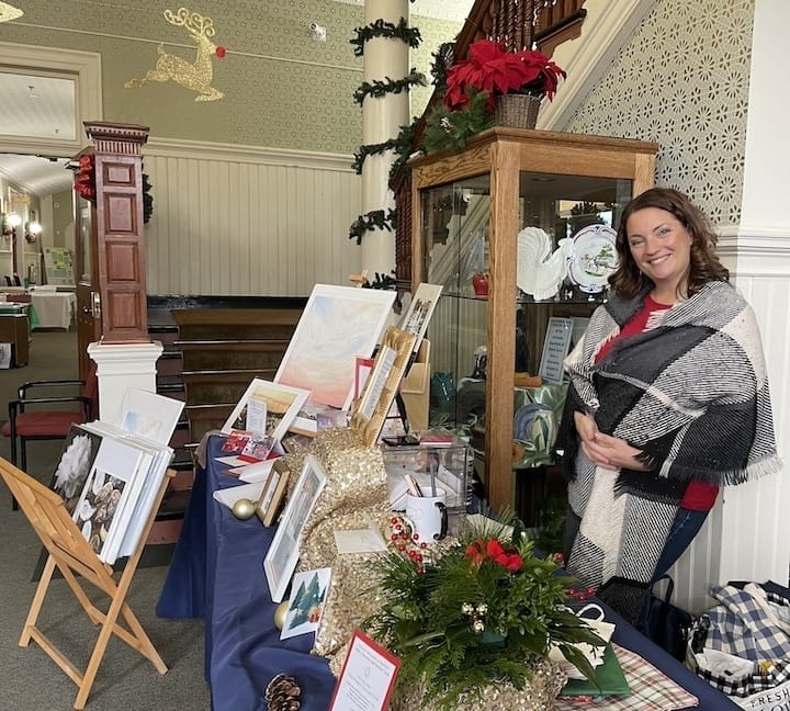 [CREDIT: Rob Borkowski] Kristina Petrilli, co-owner Shirley Mediciof Faith & Grace Design Studios was set up inside City Hall at the Rolling, Strolling Apponaug Winter Festival Dec. 9.