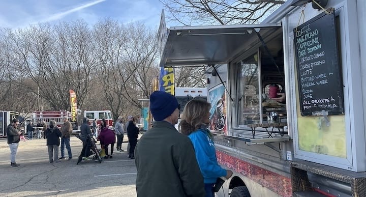 [CREDIT: Rob Borkowski] At the start of the Apponaug Winter Festival goers grab some hot drinks before the parade begins.