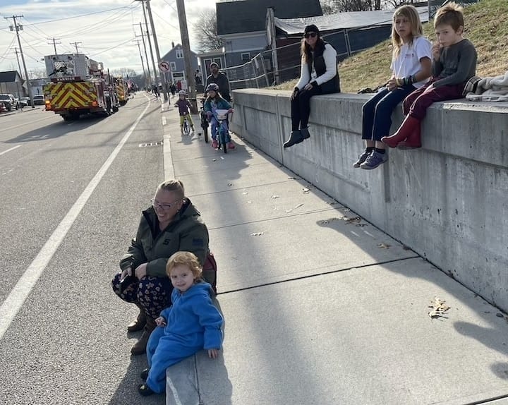 [CREDIT: Rob Borkowski] Renee Sullivan and Owen, 2, having fun on Post Road watching the Apponaug Winter Festival parade Dec. 9. 